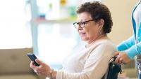 Female patient looks at her phone